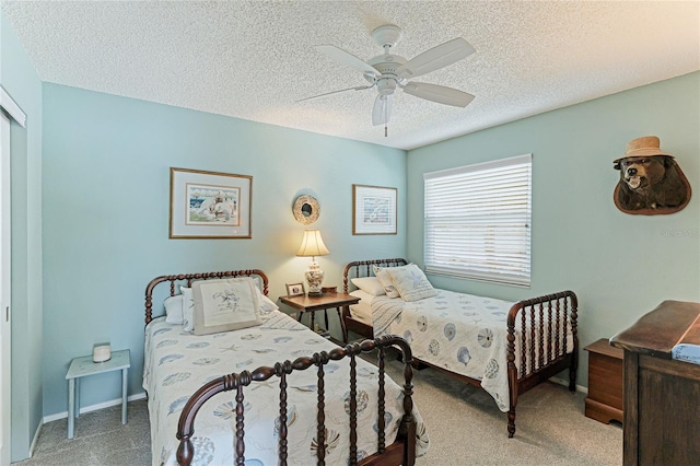 carpeted bedroom with a textured ceiling and ceiling fan