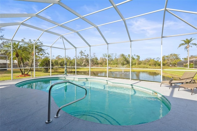 outdoor pool with glass enclosure, a patio, and a water view