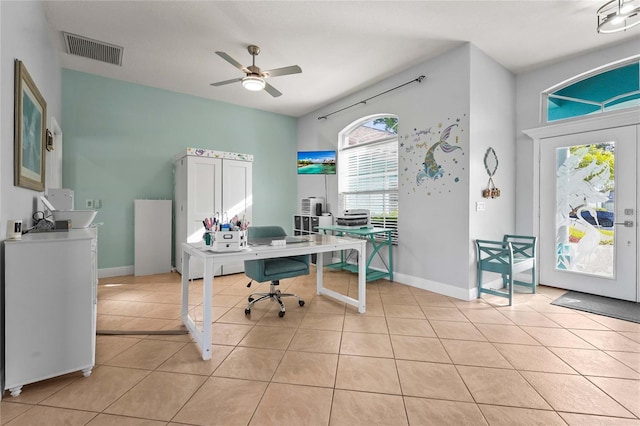 office area with light tile patterned floors, visible vents, baseboards, and ceiling fan