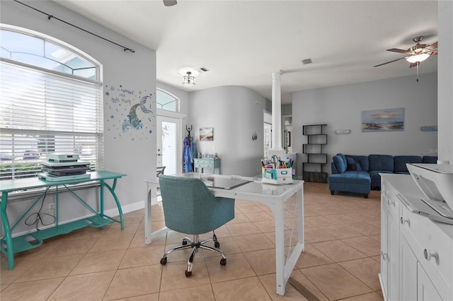 office space featuring light tile patterned floors, visible vents, baseboards, and a ceiling fan