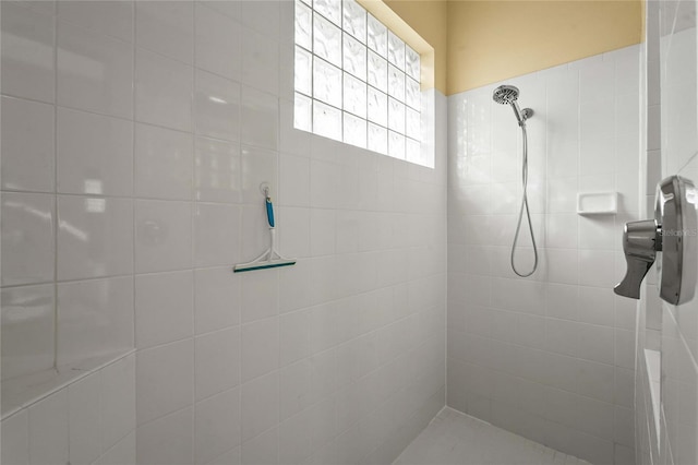 full bath with a tile shower