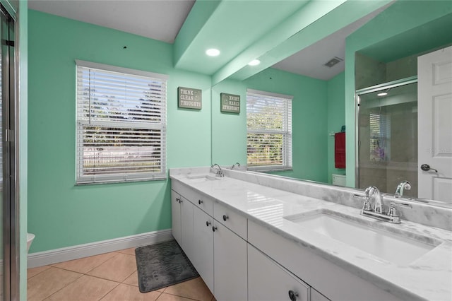 bathroom featuring a stall shower, toilet, and a sink