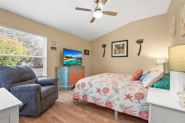 bedroom with vaulted ceiling, light wood-type flooring, and ceiling fan