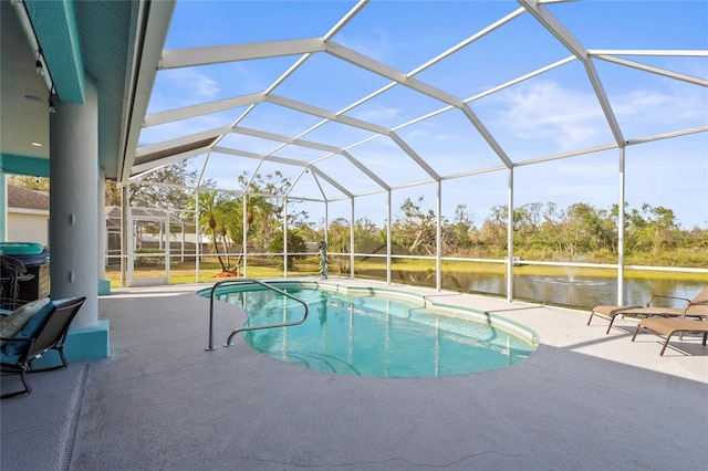 outdoor pool featuring a water view, a patio, and a lanai