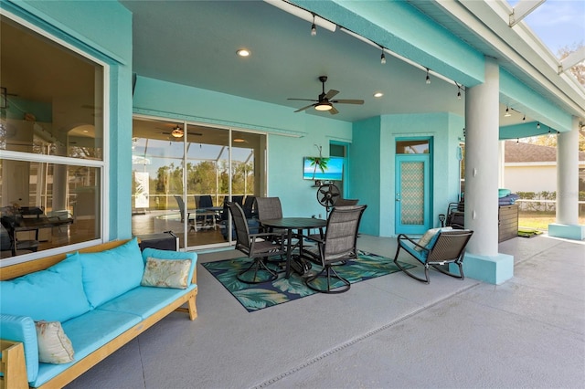 view of patio with outdoor dining area and ceiling fan