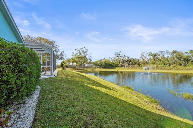 view of yard featuring a water view and a lanai