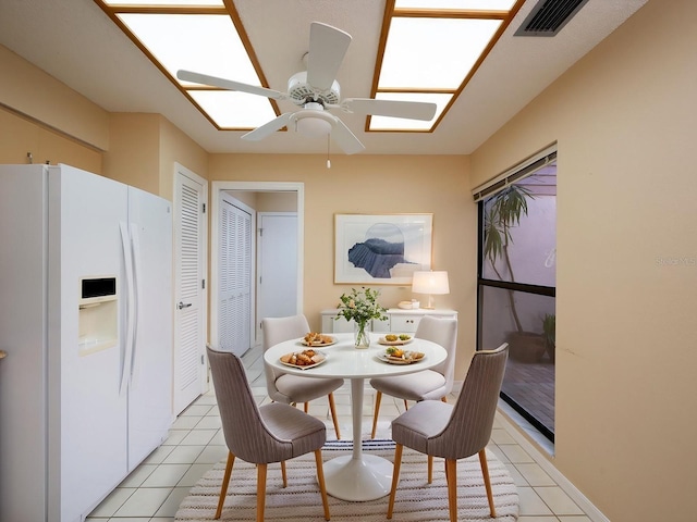 tiled dining space featuring ceiling fan