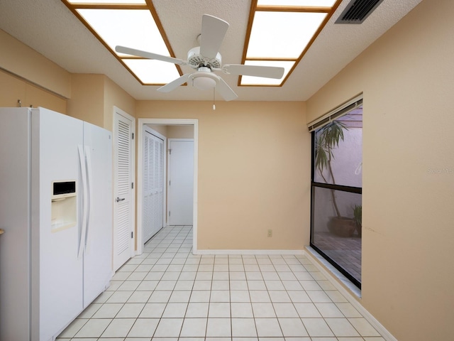 kitchen with ceiling fan and white refrigerator with ice dispenser