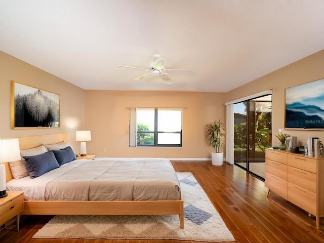 bedroom with access to exterior, ceiling fan, and dark hardwood / wood-style flooring