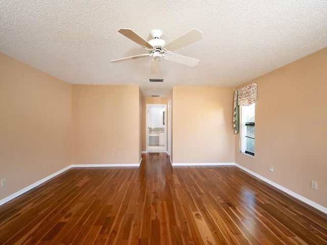 unfurnished room featuring ceiling fan, dark wood-type flooring, and a textured ceiling