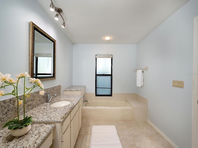 bathroom featuring tile patterned flooring, vanity, and a tub