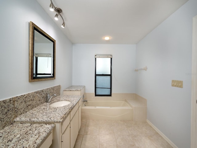 bathroom with tile patterned flooring, a washtub, and vanity