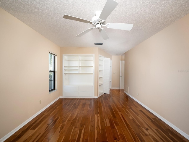 unfurnished bedroom with a textured ceiling, a closet, ceiling fan, and dark wood-type flooring