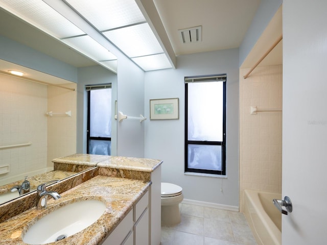 full bathroom featuring tiled shower / bath, tile patterned flooring, vanity, and toilet