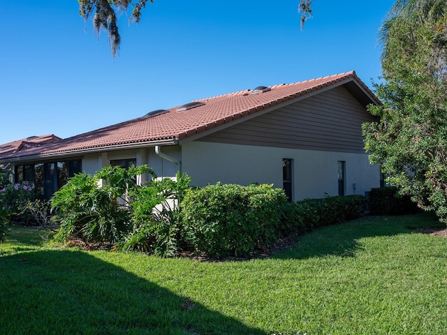 view of home's exterior featuring a lawn