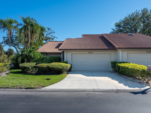 view of front of property with a front yard and a garage