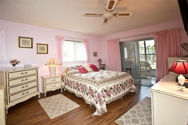 bedroom featuring access to exterior, a textured ceiling, ceiling fan, and dark wood-type flooring