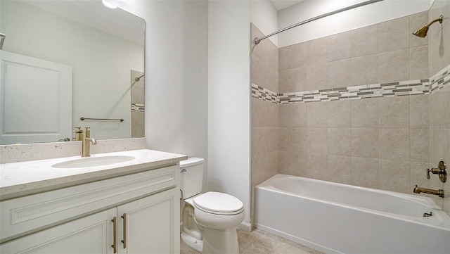 full bathroom featuring tile patterned floors, tiled shower / bath combo, toilet, and vanity