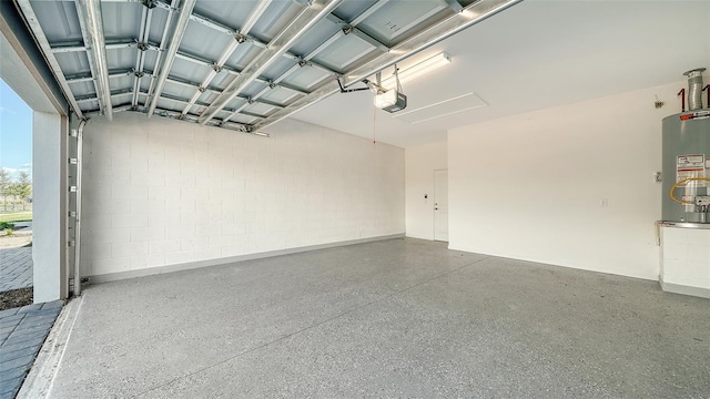 garage featuring water heater and a garage door opener