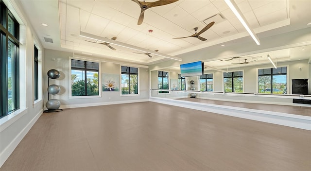 workout area featuring a tray ceiling