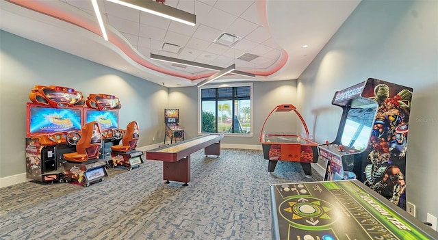 rec room with a tray ceiling and carpet