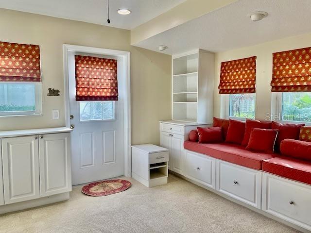 mudroom with light colored carpet