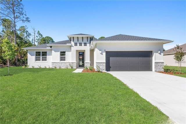 prairie-style home featuring a front lawn and a garage