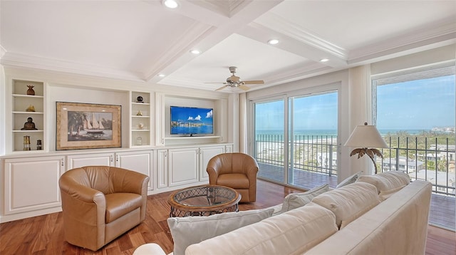 living room with hardwood / wood-style flooring, ceiling fan, ornamental molding, and beamed ceiling