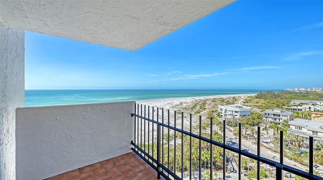 balcony featuring a water view and a view of the beach