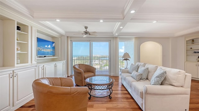 living room featuring crown molding, beamed ceiling, light hardwood / wood-style floors, and ceiling fan