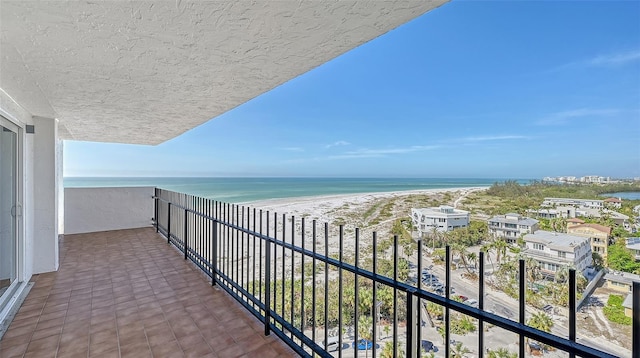 balcony with a water view and a beach view