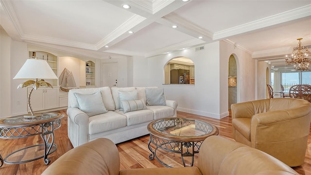 living room with light wood-type flooring, ornamental molding, coffered ceiling, beam ceiling, and a chandelier