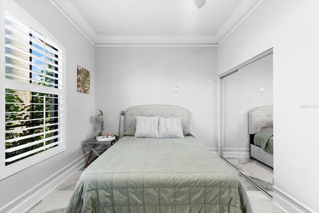 bedroom featuring crown molding and a closet