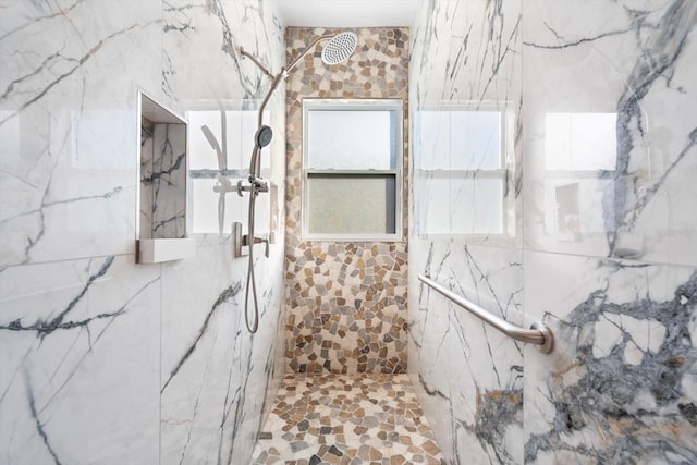 bathroom with a tile shower