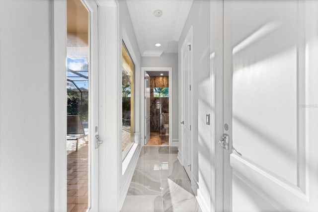 doorway to outside featuring crown molding