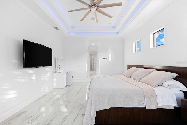 bedroom featuring ornamental molding, ceiling fan, and a tray ceiling