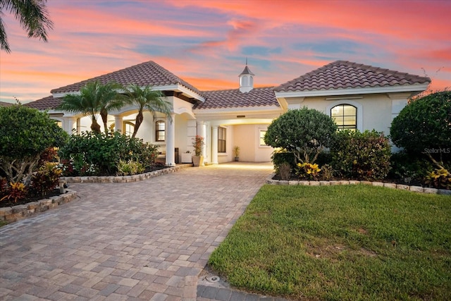 mediterranean / spanish-style house featuring a yard