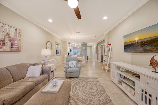 living room with light tile patterned floors, ceiling fan with notable chandelier, and ornamental molding