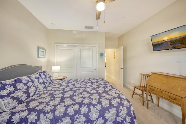 bedroom featuring light carpet, a closet, and ceiling fan