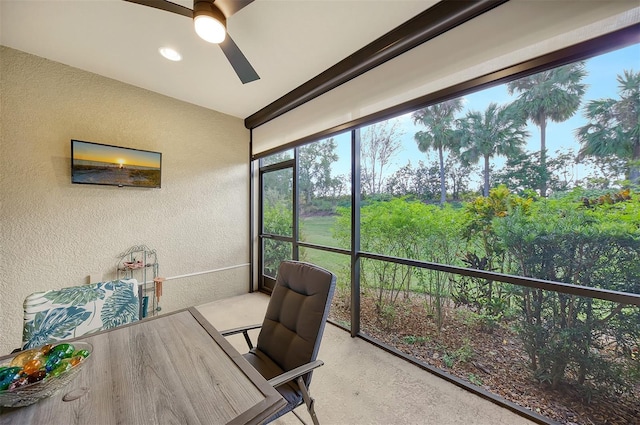 sunroom featuring ceiling fan