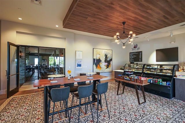 dining space with a chandelier, hardwood / wood-style floors, and wood ceiling