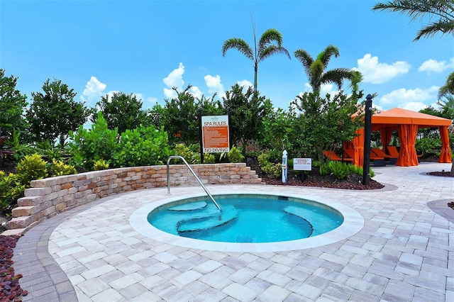 view of swimming pool featuring a gazebo, a patio, and a hot tub