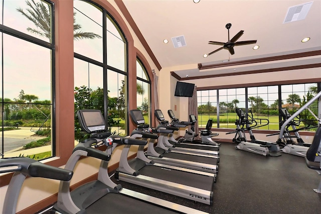 exercise room with ceiling fan and a towering ceiling