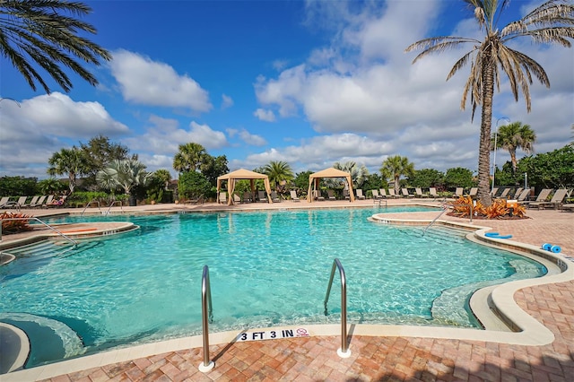 view of swimming pool with a gazebo and a patio area