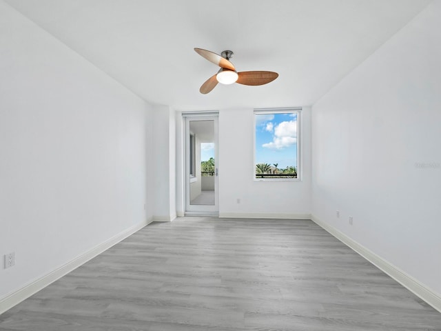 empty room with ceiling fan and light wood-type flooring