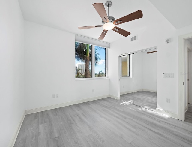 unfurnished bedroom with a closet, light hardwood / wood-style flooring, and ceiling fan