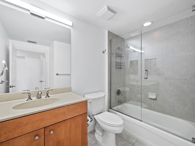 full bathroom featuring tile patterned floors, vanity, enclosed tub / shower combo, and toilet