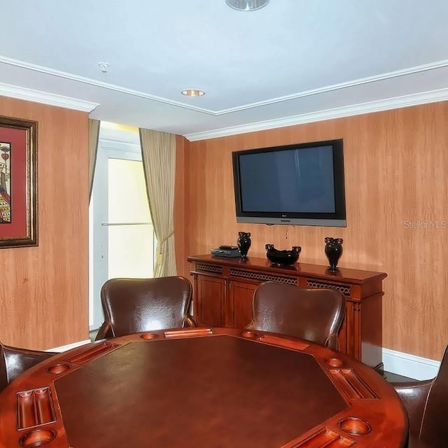 unfurnished room featuring crown molding and wooden walls