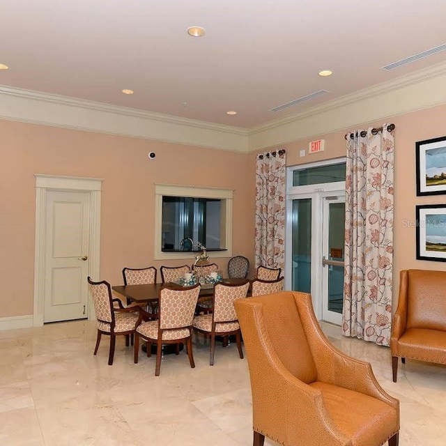 dining space with crown molding