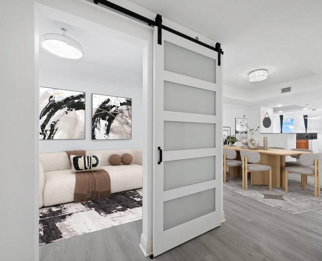 interior space featuring a barn door and hardwood / wood-style flooring